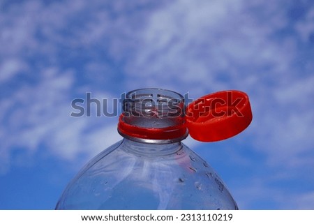                                
new cap of a plastic bottle, where the screw cap remains on the ring so that it does not end up in the environment individually Royalty-Free Stock Photo #2313110219