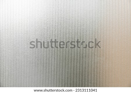 clear glass background and texture. Transparent material Corrugated glass surface use for partition wall, door or roofing. close up photo. Royalty-Free Stock Photo #2313111041