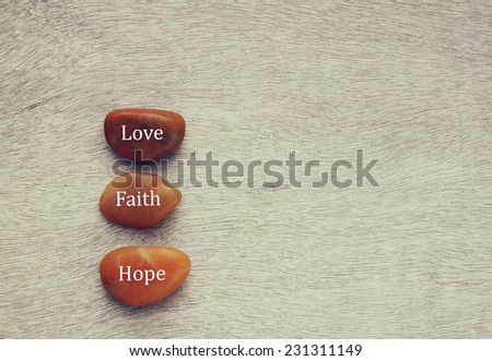 River stones with words written on them. love, faith and hope concept 