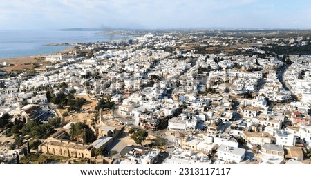Panoramic aerial view with drone shooting at the city on the island and the blue calm sea and clear sky of Larnaca Cyprus.