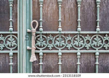 Porto, Portugal - February 15, 2023: Old metallic grille or grate in a door.