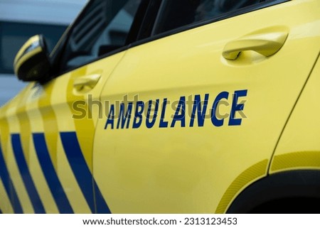 Dutch ambulance in the Netherlands with characteristic striping seen from the side. Narrow depth of field, focus on the letter N Royalty-Free Stock Photo #2313123453