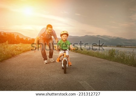 Happiness Father and son on the bicycle outdoor Royalty-Free Stock Photo #231312727