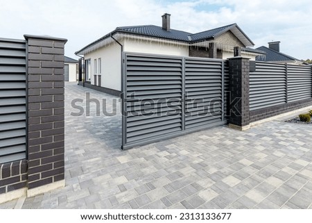 Fragment of a modern fence lined with decorative bricks in the old style. Royalty-Free Stock Photo #2313133677