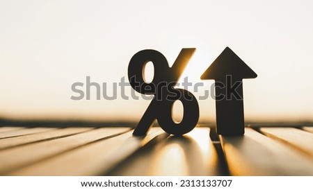 Silhouette of percentage model and up arrow with evening sky Key concepts for success, methods, systems of raising or lowering Fed interest rates to correct inflation concepts. Royalty-Free Stock Photo #2313133707
