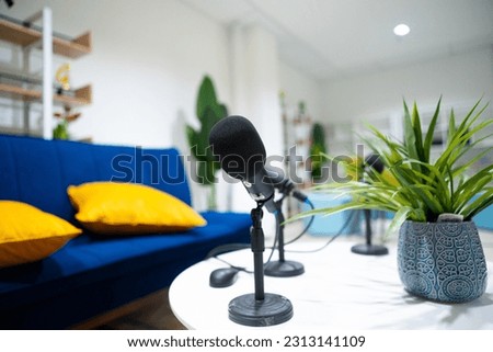 Simple studio room with blue chairs. Podcast media studio to broadcast audio. Audio settings for podcasting, microphone, speech, or interview. Royalty-Free Stock Photo #2313141109