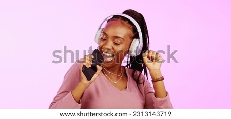 Sing, dance and black woman with headphones music microphone isolated on a studio background. Fun, happy and funky African girl listening to audio, radio or songs while singing and dancing on a backd Royalty-Free Stock Photo #2313143719