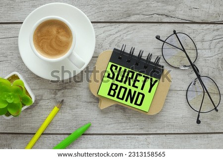 Surety bonds two wooden blocks on gray background business concept