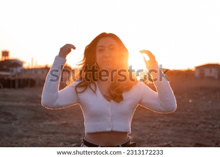 Beautiful girl in front of bright sunshine halo