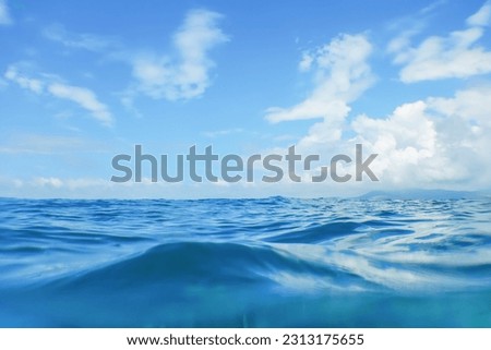 Sea Wave Close-up, Low Angle view Tropical Island on the surface Royalty-Free Stock Photo #2313175655