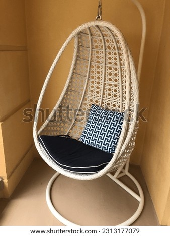 Rattan lounge chair with blue and black cushion