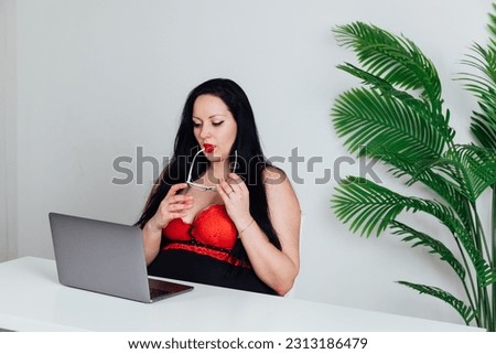 a woman in the office at the computer office work online internet