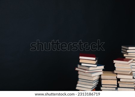stack of books in the library on a black background training education science