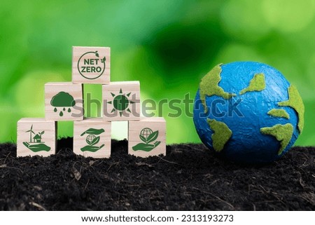 Paper globe and wooden cube with net zero symbol for eco awareness. Reduce CO2 emission, fight climate change and global warming by clean energy for environmental protection. Alter