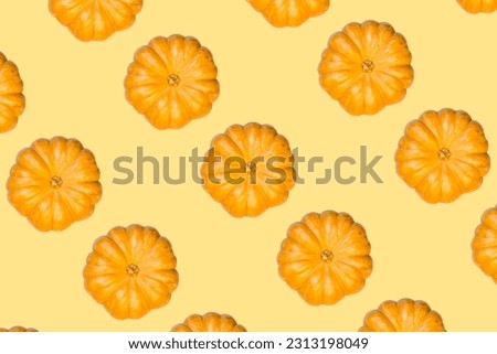 orange pumpkin print top view on light yellow background. High quality photo