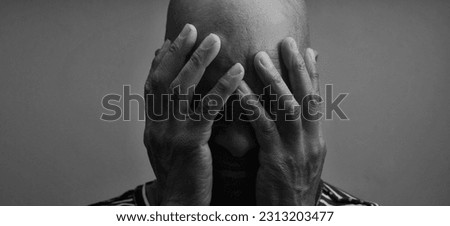 man praying to god with hands together Caribbean man praying on black background with people stock photos stock photo