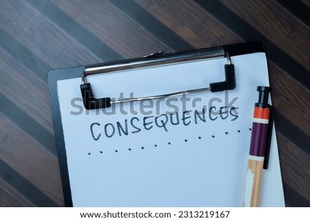 Concept of Consequences write on paperwork isolated on Wooden Table. Royalty-Free Stock Photo #2313219167