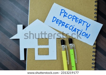 Concept of Property Depreciation write on sticky notes isolated on Wooden Table.
