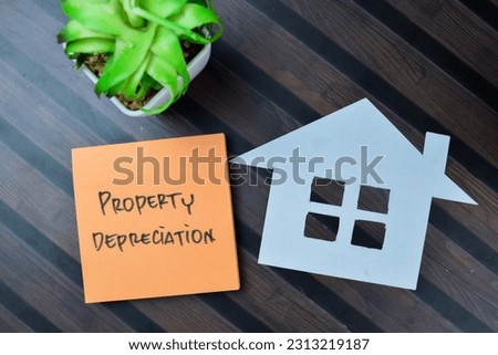 Concept of Property Depreciation write on sticky notes isolated on Wooden Table. Royalty-Free Stock Photo #2313219187