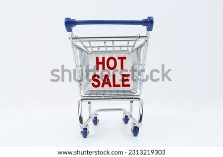 Business concept. On a white background is a shopping cart with a sign that says - HOT SALE