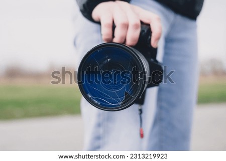 A DSLR camera with broken lens filter. Cracked photo-filter