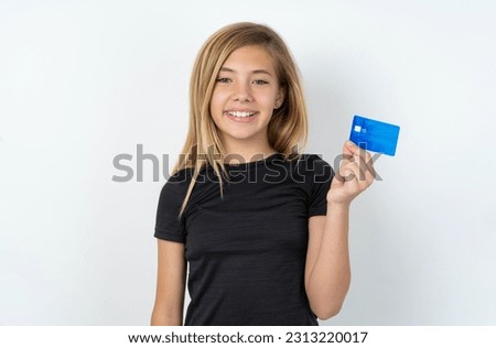 Photo of happy cheerful smiling positive beautiful caucasian teen girl wearing sportswear over white wall recommend credit card
