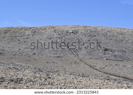 Rocky landscape at Krk island intersected with dry stone wall