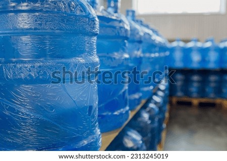 Plastic water bottles on conveyor and water bottling machine industry.
