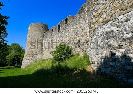 Low-angle view of the walls of the medieval castle of Yèvre le Châtel and its four round corner towers in the department of Loiret, France