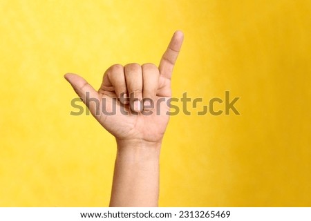 Hands of a Latino man makes sign language, expression and gesture-spatial configuration and visual perception with which deaf people establish a channel of communication