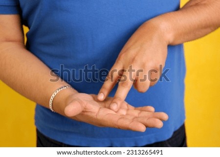 Hands of a Latino man makes sign language, expression and gesture-spatial configuration and visual perception with which deaf people establish a channel of communication