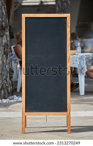 Empty menuboard on in front of a restaurant or cafe, blank chalkboard, no text