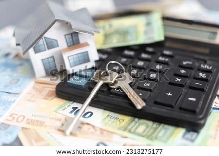 Model house, calculator, euro notes Royalty-Free Stock Photo #2313275177