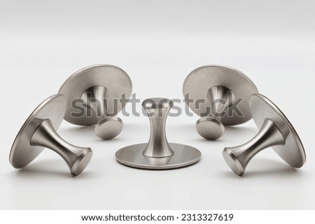 Adhesive holders in stainless steel. Self adhesive hooks isolated on white background.