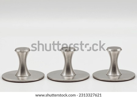 Adhesive holders in stainless steel. Self adhesive hooks isolated on white background.