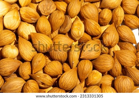 Apricot kernels, in the food industry, apricot kernels can be used in the preparation of low-fat biscuits, cookies, cakes, in the manufacture of antimicrobial films. Royalty-Free Stock Photo #2313331305