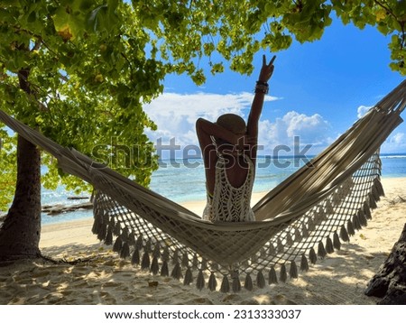 Happy traveller young woman in bikini which she is  relaxing in the hammock and freedom mood of free happiness 