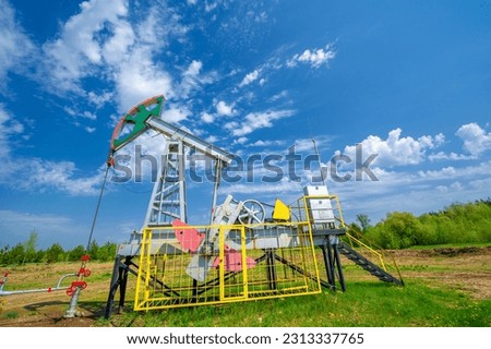 Pumping jacks are used in onshore oil wells with low productivity. They provide the mechanical power to operate the piston pump. Common in oil-rich regions around the world Royalty-Free Stock Photo #2313337765