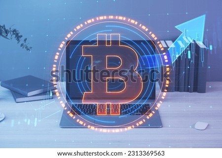 Close up of notebook at workplace with supplies and glowing round bitcoin sign and forex chart hologram on blurry background. Cryptocurrency, metaverse and blockchain concept. Double exposure