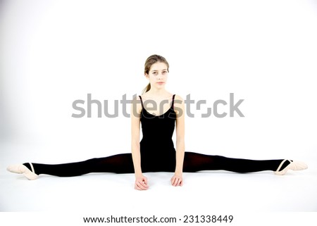 Cute teenager ballerina doing split
