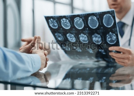 patient at a reception at the doctor looking an x-ray Royalty-Free Stock Photo #2313392271