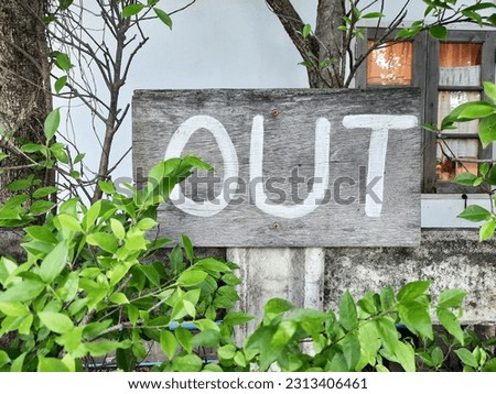 wooden sign indicates an exit.