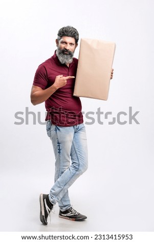 Indian man holding box on white background.