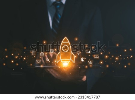 The hand shows a rocket. Concept of Startup Business, Entrepreneurship Idea, and Online Digital Business. network connection on the interface Marketing, Technology, and Success