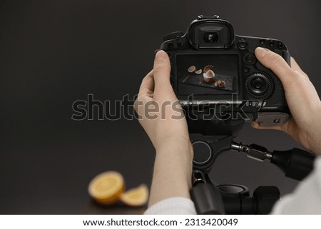 Food stylist taking photo of delicious dessert in studio, closeup. Space for text