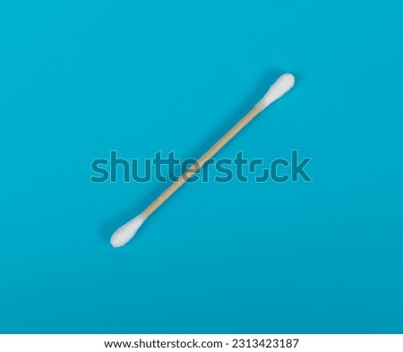 Cotton Swabs, Eco Natural Paper Ear Sticks, Biodegradable Hygiene Bud, Earwax Cleaner Swab, Ear Sticks on Blue Background Royalty-Free Stock Photo #2313423187