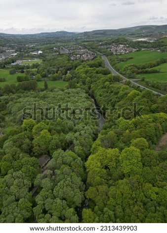Aerial view of green trees and surrounding farmland. Taken in Bury Lancashire England.