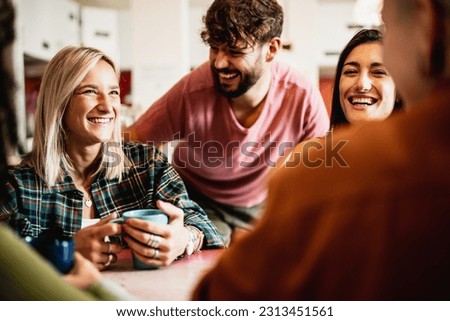 Morning breakfast at the youth hostel, different people smile and sip coffee in the cafeteria of a youth hotel, backpackers and travelers lifestyle Royalty-Free Stock Photo #2313451561