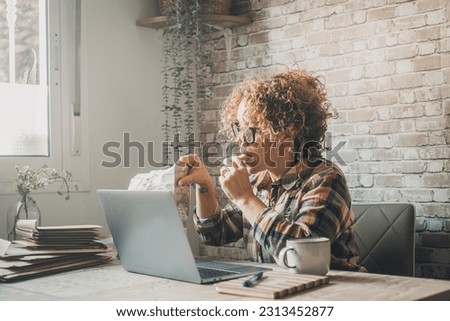 New business lifestyle concept in home office workplace. One woman working and eating cookies at the same time. Busy business people using computer wireless connection to work online alone indoor Royalty-Free Stock Photo #2313452877