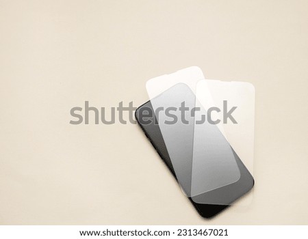 glass film change,repair and maintenance smartphone.hand in glove holding screen protection.flying in air tempered glass and phone.medical stethoscope meaning mobile doctor.tools and display napkin Royalty-Free Stock Photo #2313467021